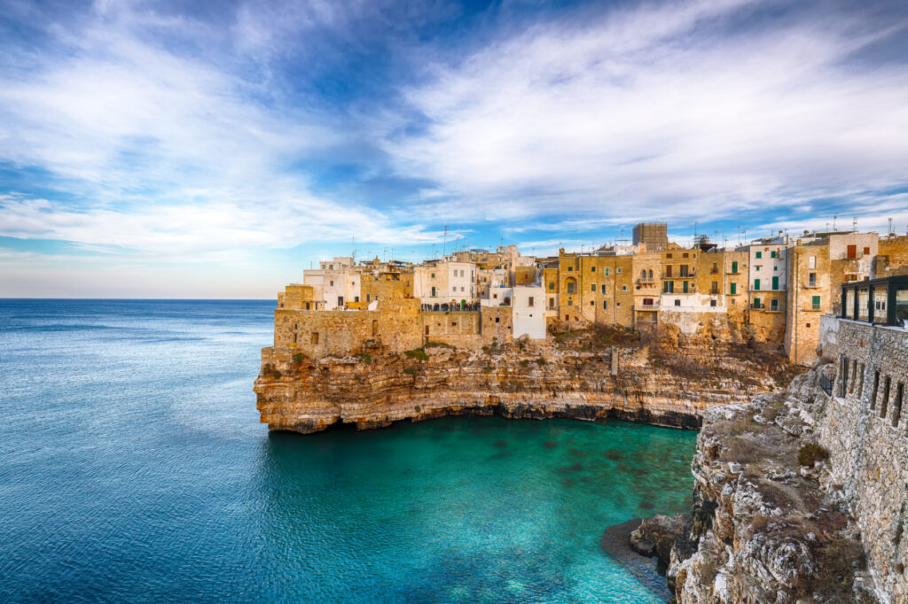 Polignano a Mare village on the rocks at sunset